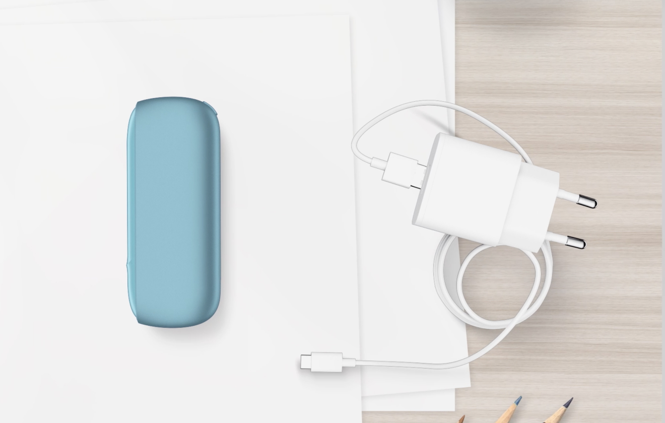 Turquoise IQOS ORIGINALS DUO pocket charger next to cable charger.